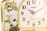 Rhythm Alarm Mantel Clock with Rotating Swarovski Crystal Pendulum Gilt